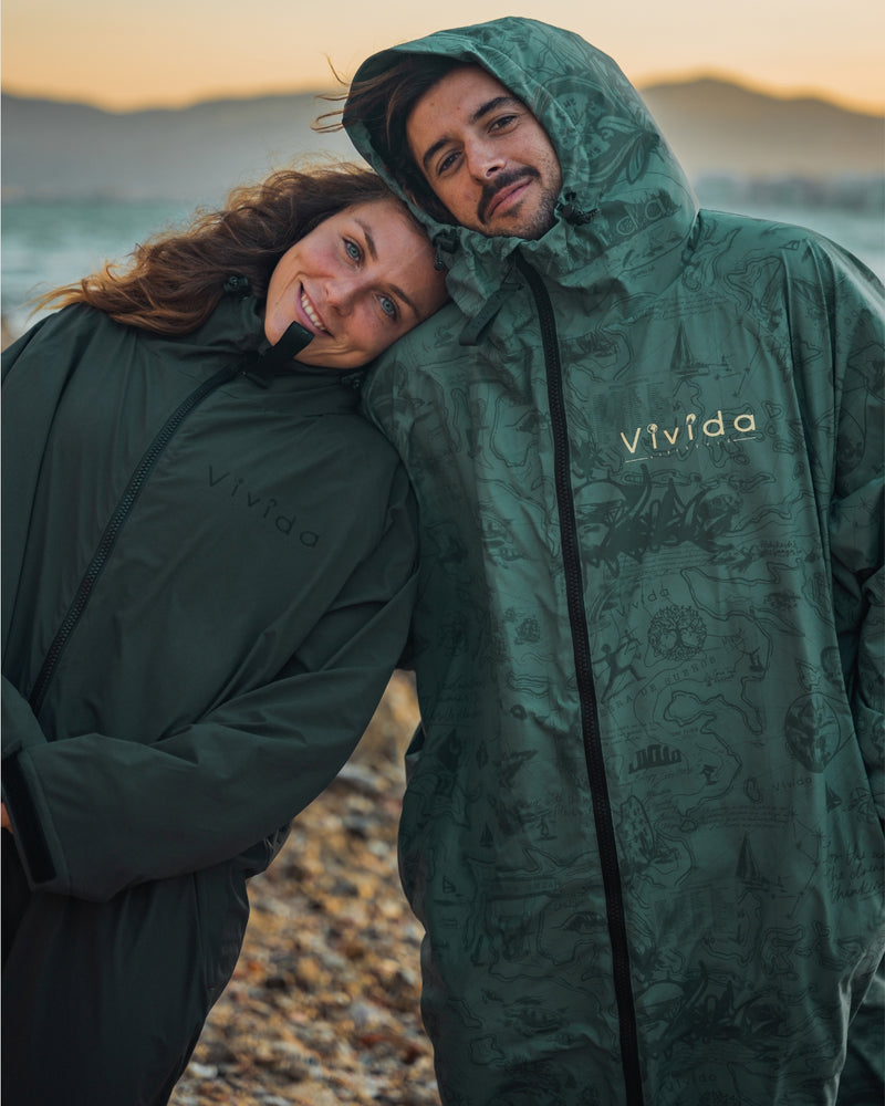 Woman with Man wearing a Vivida sherpa weatherproof changing robe Green Map of Dreams