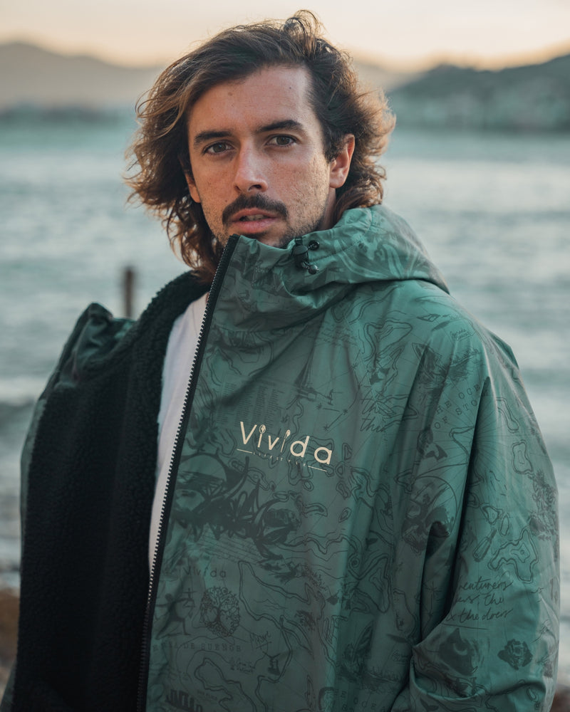 Man wearing a Vivida sherpa weatherproof changing robe Green Map of Dreams